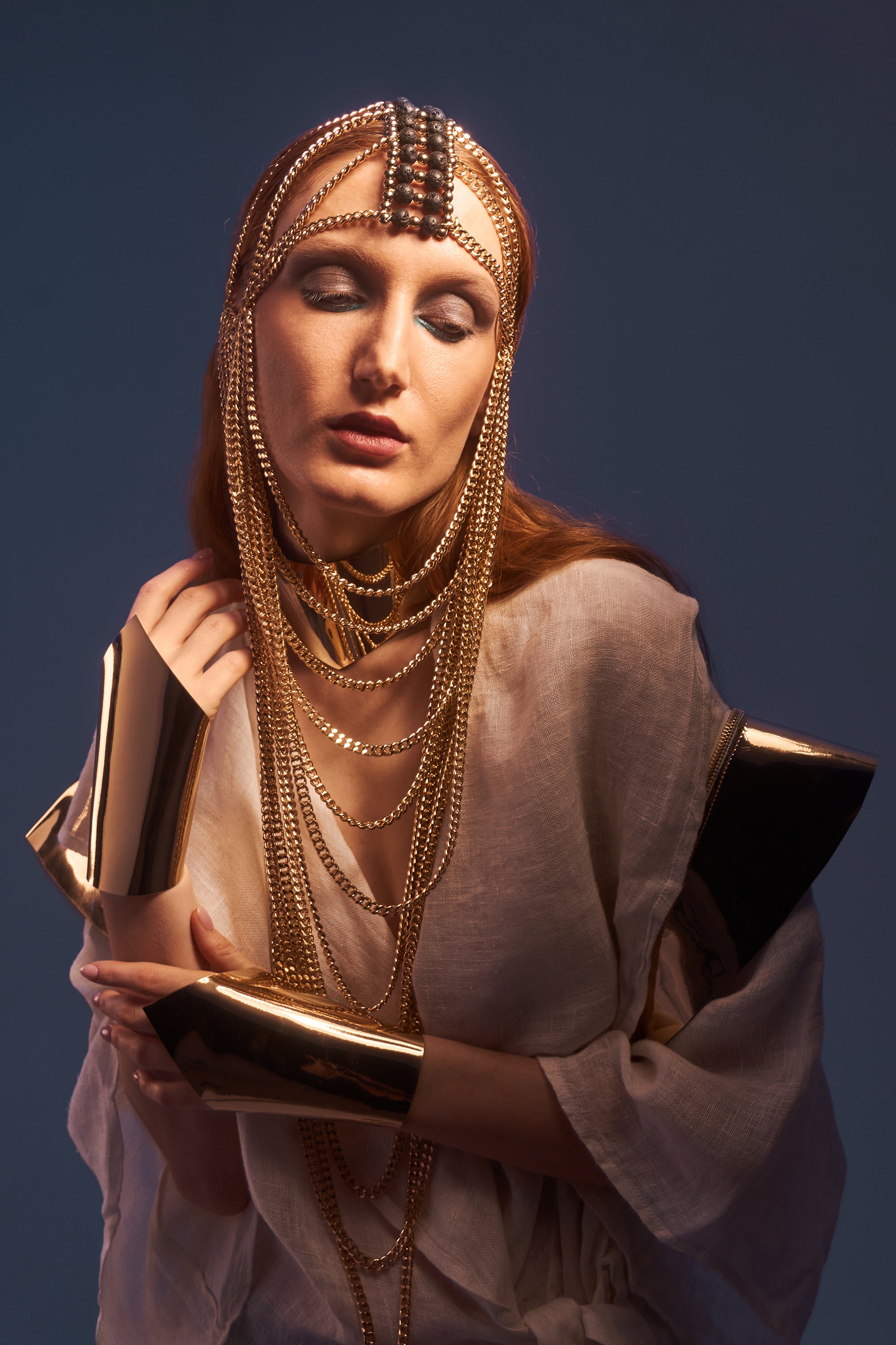 Gold chain mask with lava stone